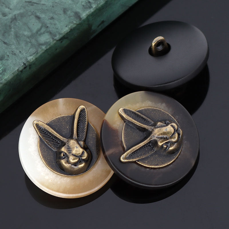 Rabbit head shank buttons, beige and black colors, front details visible