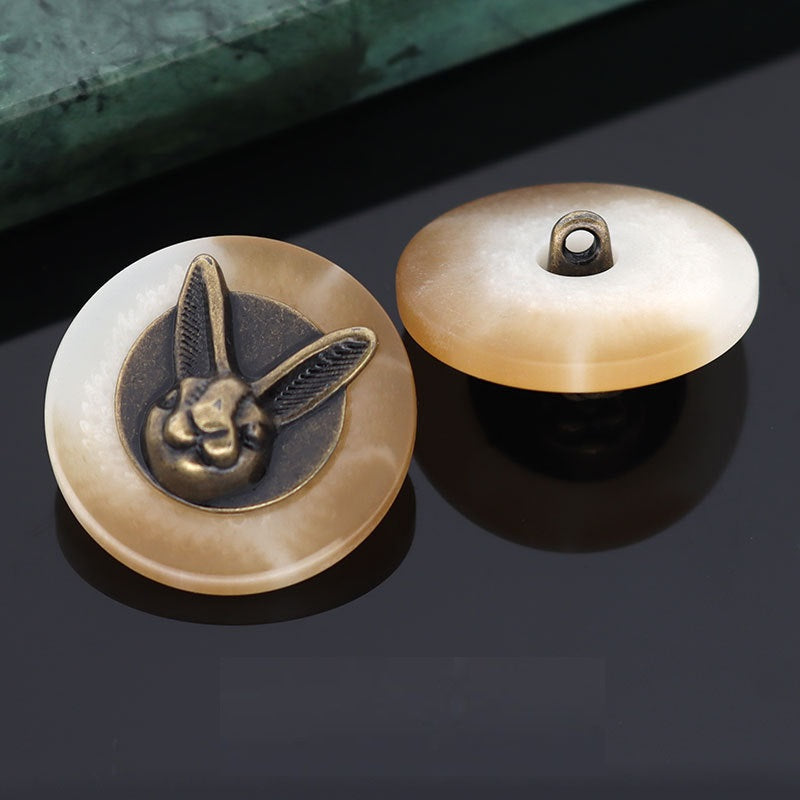 Beige rabbit head shank button front and matching back with metal loop