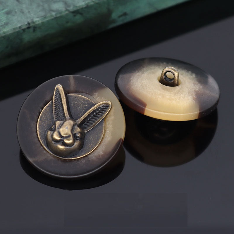 Black rabbit head shank button front with metal loop; beige back shown