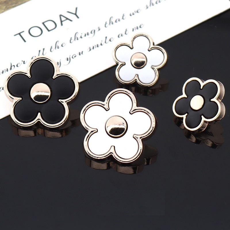 Black and white floral shank buttons with silver-tone metal outline and back stud