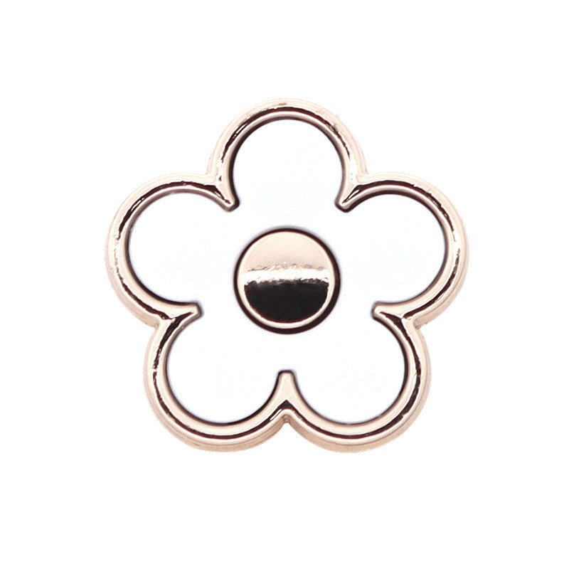 White floral shank button with silver-tone metal rim and dark resin center