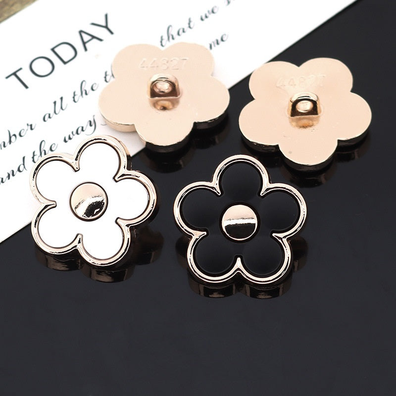 Set of white and black floral shank buttons with silver-tone metal shank