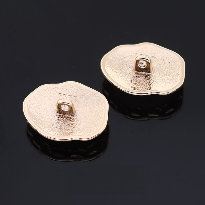 White resin buttons with gold-tone metal shanks on textured backs (2-pack)