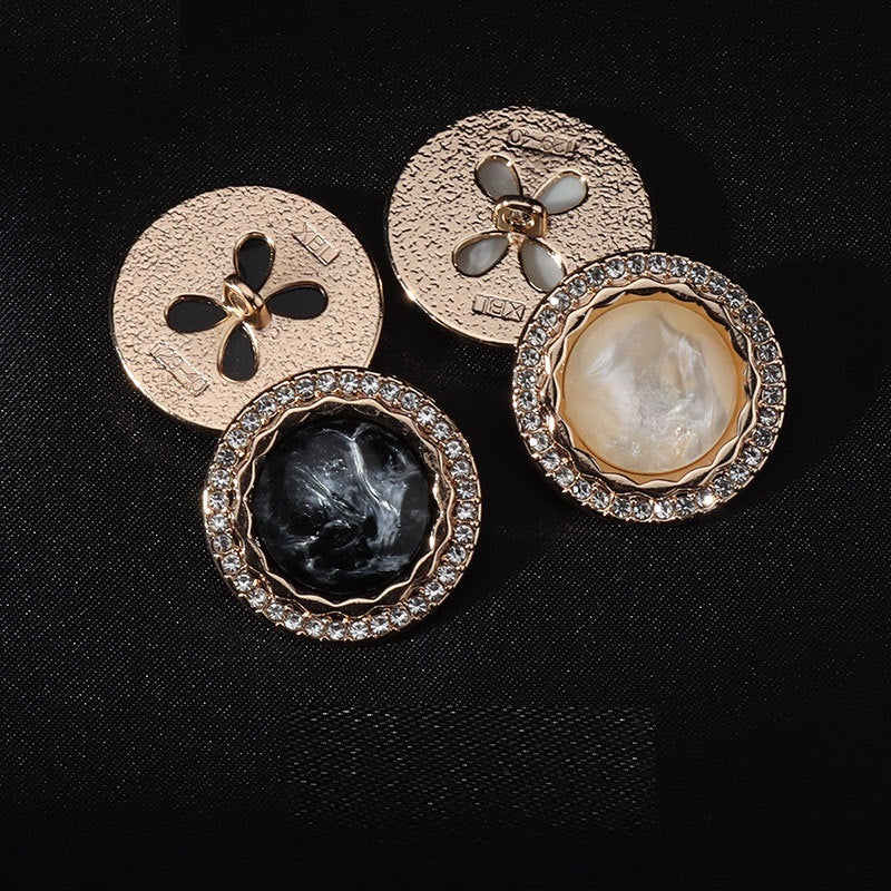 Back and front view of gold-toned shank buttons with clear rhinestone edge and pearl center