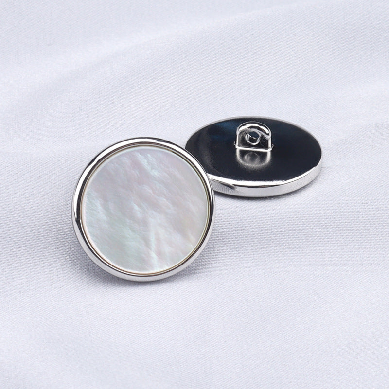 Two-piece view: round mother-of-pearl jacket button with metal shank backing