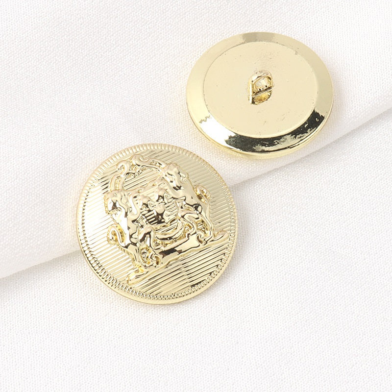 Gold round metal shank button with lion crest front and plain back