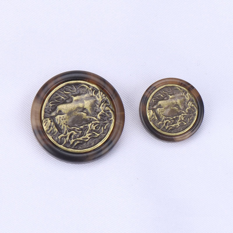Set of two lion head buttons, dark brown with gold embossed lion design, round