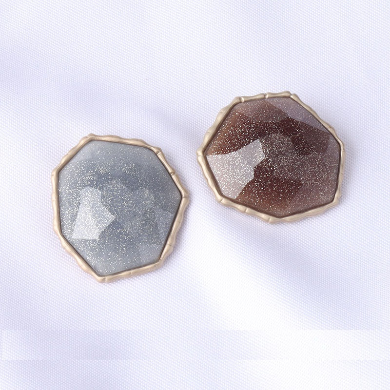 Pair of shank buttons: blue and brown octagonal fronts with metal edges