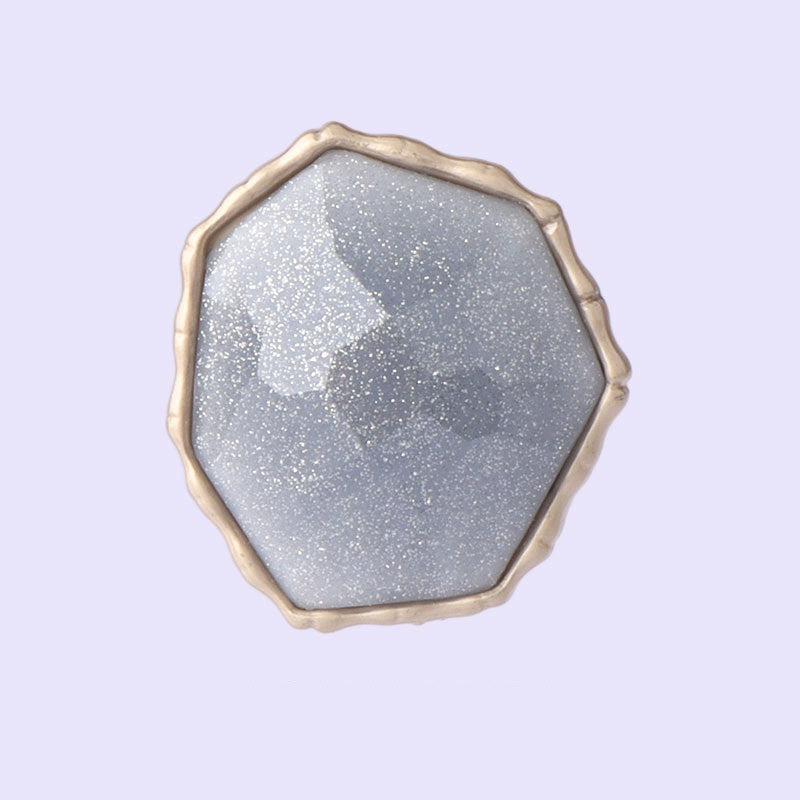 Blue octagonal shank button with textured face and gold-tone metal rim