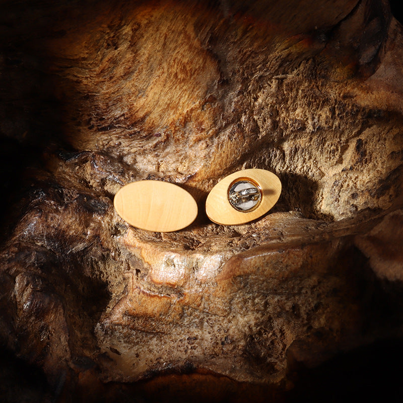 Oval natural wood buttons showing two 15mm pieces with attached shanks