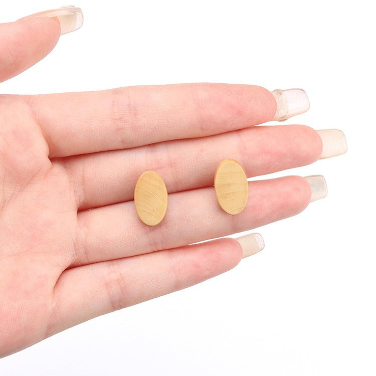 15mm oval natural wood button on hand for size, with shank back