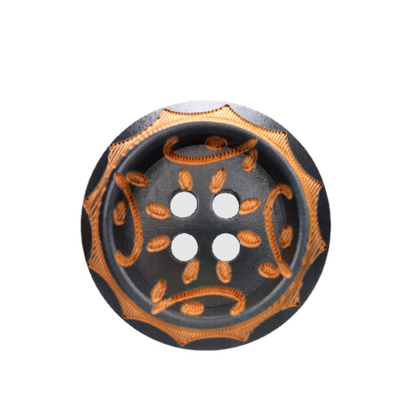 Gray-brown vintage wood button with four holes and ornate gold swirl design