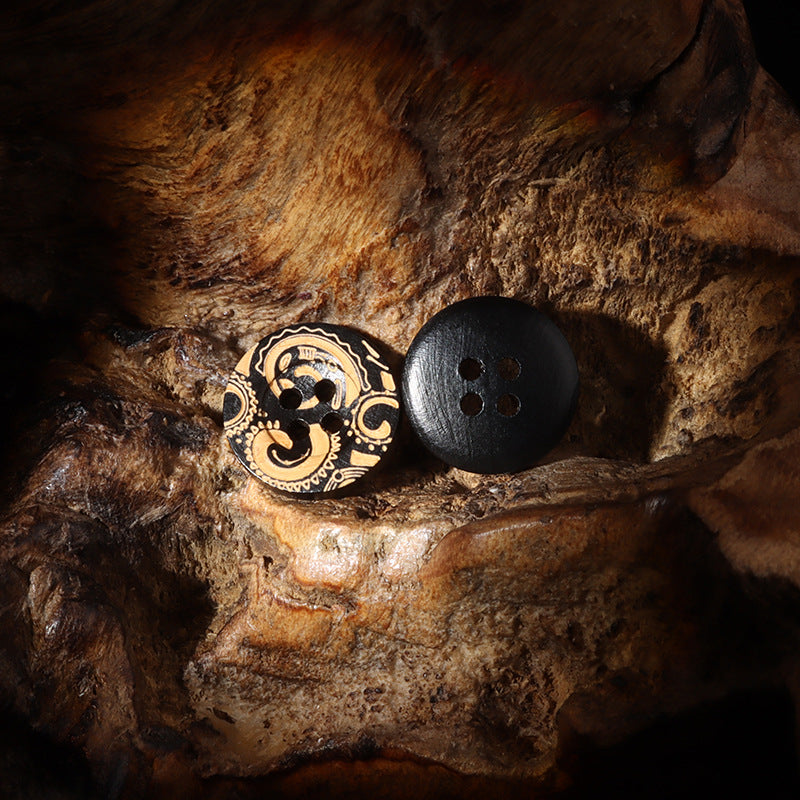 Black round 4-hole wood button with gold carved vintage design (two angles)