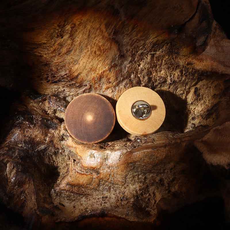 Two round high-foot wood buttons, dark and light brown, metal shank visible