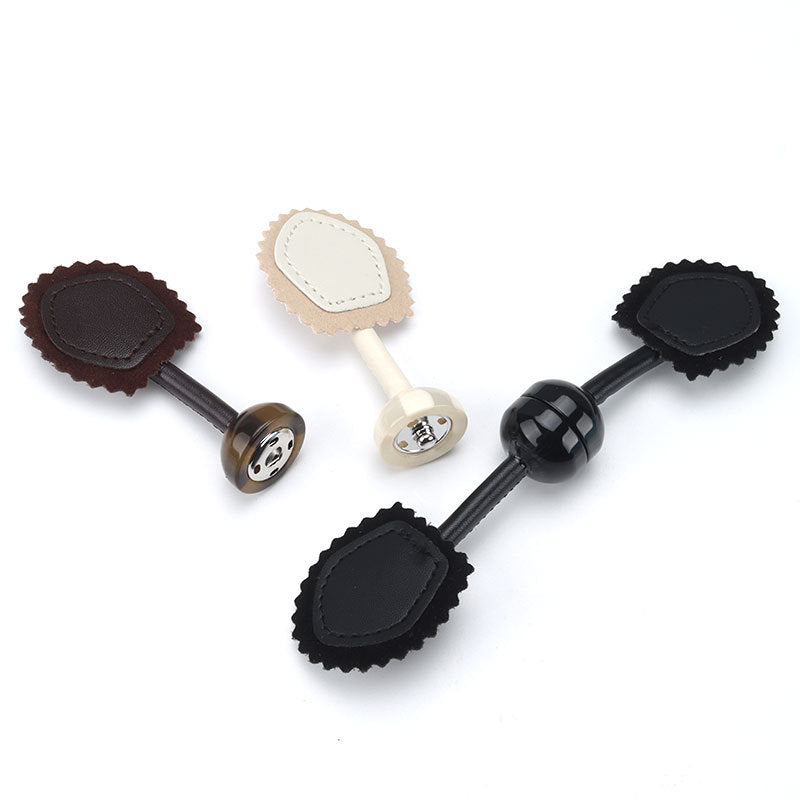 Leather buckle snap buttons in black, beige and brown with resin posts and scalloped pads