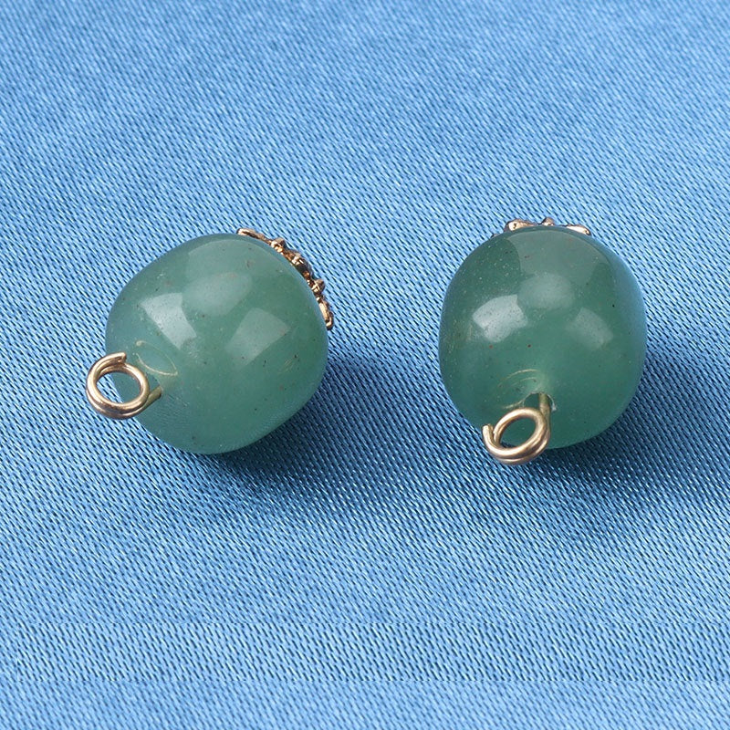 Green natural jade bead buttons showing gold loop and metal bezel edge detail