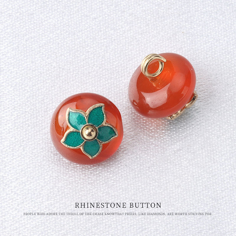 Red natural jade button pair with green flower mounts and gold loop backs