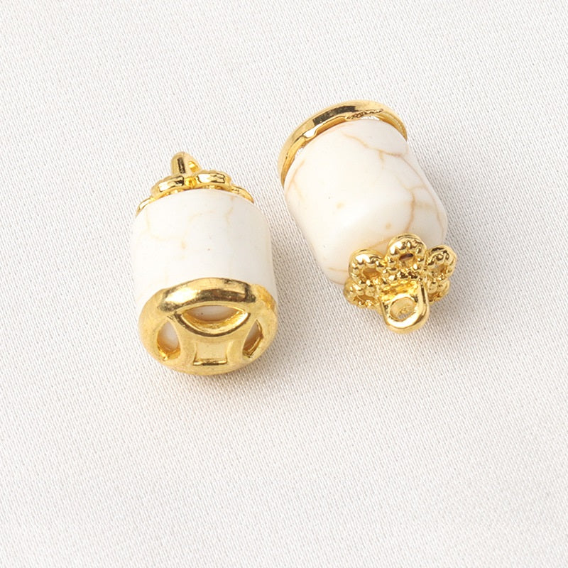 White resin flower mount buttons, cylindrical shape with gold shank and flower detail