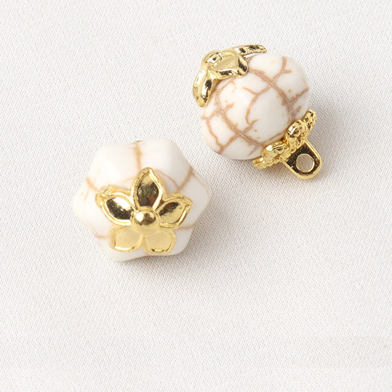 White resin flower mount buttons, hexahedral shape with gold flower setting and shank