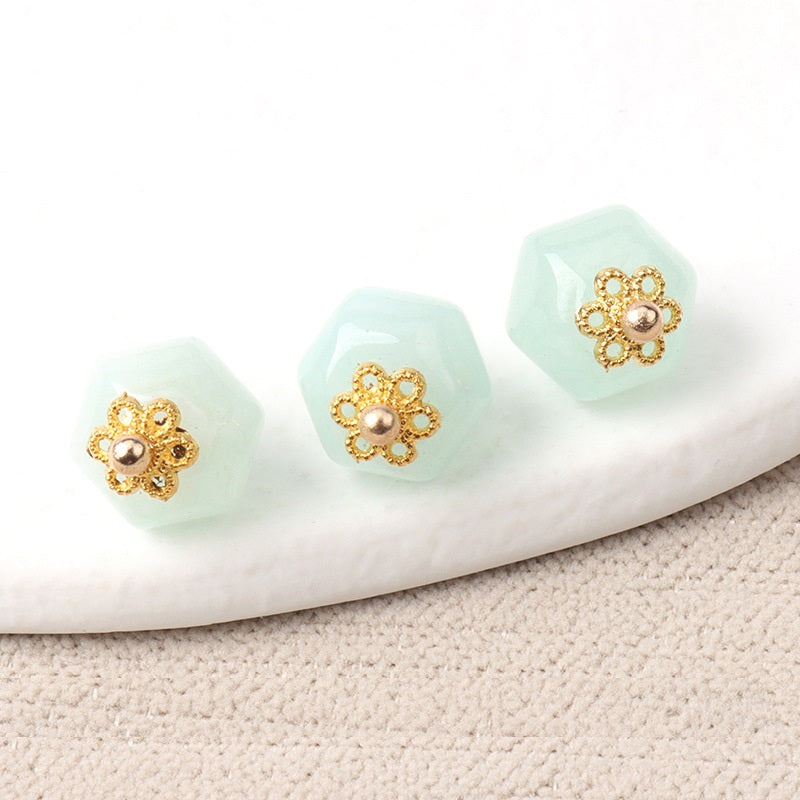 Light aqua 11mm jade polyhedron buttons with gold flower filigree and pearl center