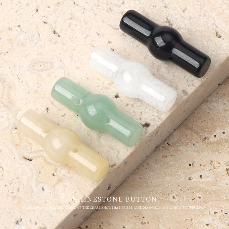 Assorted 25mm jade cylindrical buttons in black, white, green, and yellow