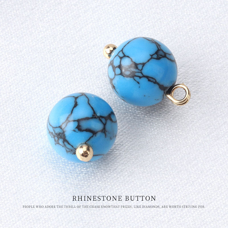 10mm round bead button in light blue with black crackle lines, gold loop and stud