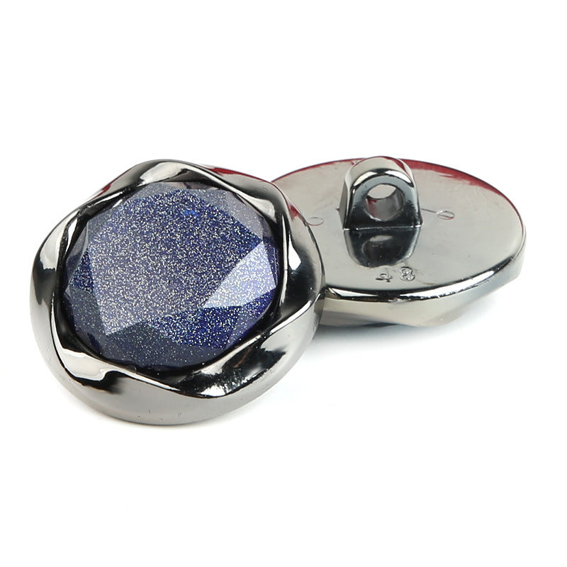 Round pearlescent plastic button with shank, dark blue top and metal-like back