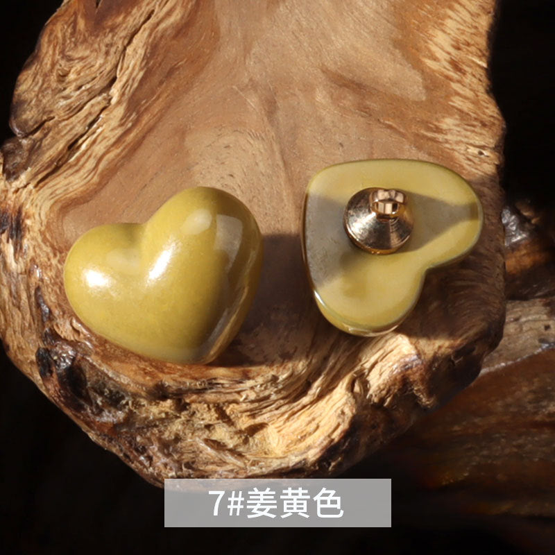 14mm heart-shaped plastic decorative button in mustard yellow with metal shank