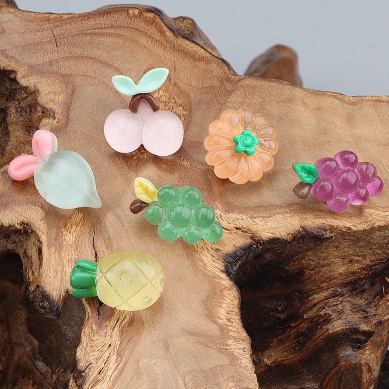 Colorful kids buttons: mint leaf pair, pink cherries, orange flower, purple grape cluster