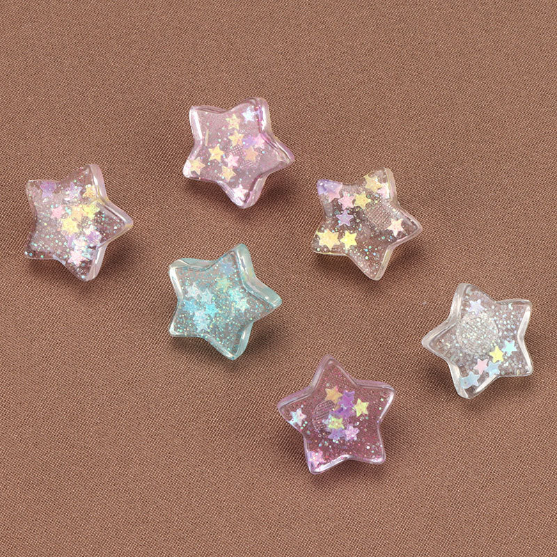 Set farbiger Stern-Kunststoffknöpfe: rosa, blau und silbern mit Glitzer-Sternen