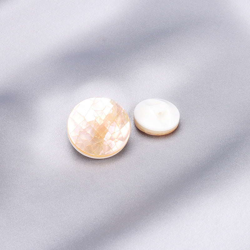 Two round natural shell buttons with iridescent white-pink mosaic finish