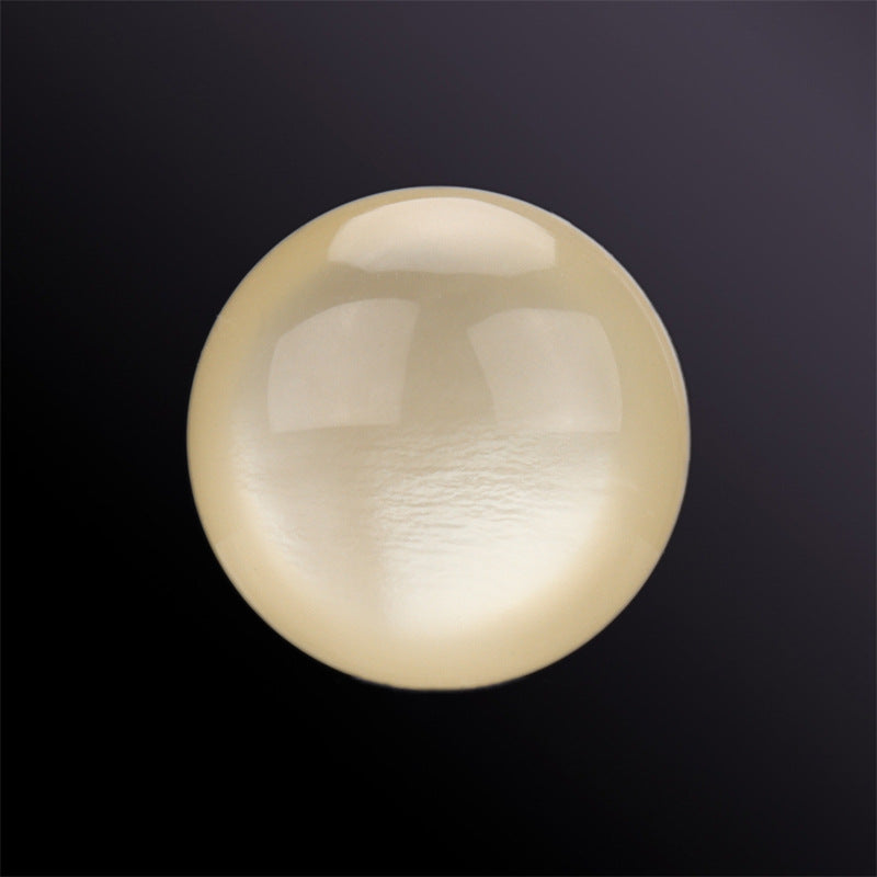 Cream hemispherical shell button, glossy iridescent sheen, close-up
