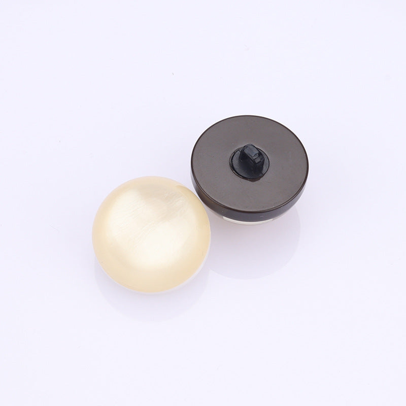 Cream shell button with dark back plate, two-piece set view