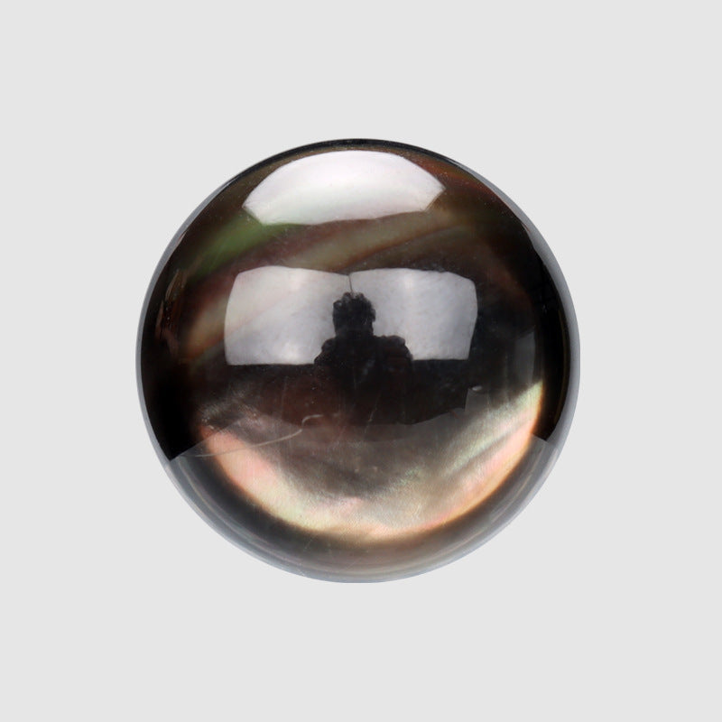 Dark iridescent shell button, hemispherical glossy front