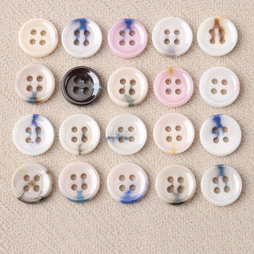 Glazed ceramic four-hole buttons: blue-white swirls on cream, pink, and gray