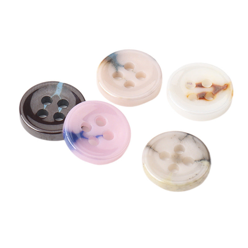 Glazed ceramic four-hole buttons set: black, pale blue, blush pink, and cream marbling