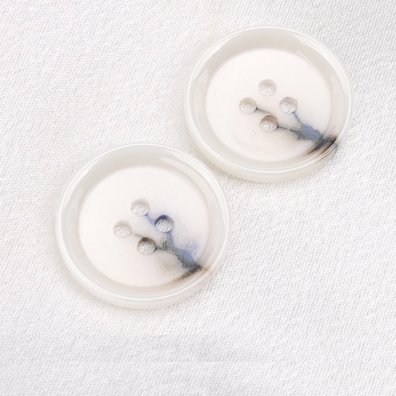Two ink blue 15–23mm round 4-hole ceramic buttons, top view