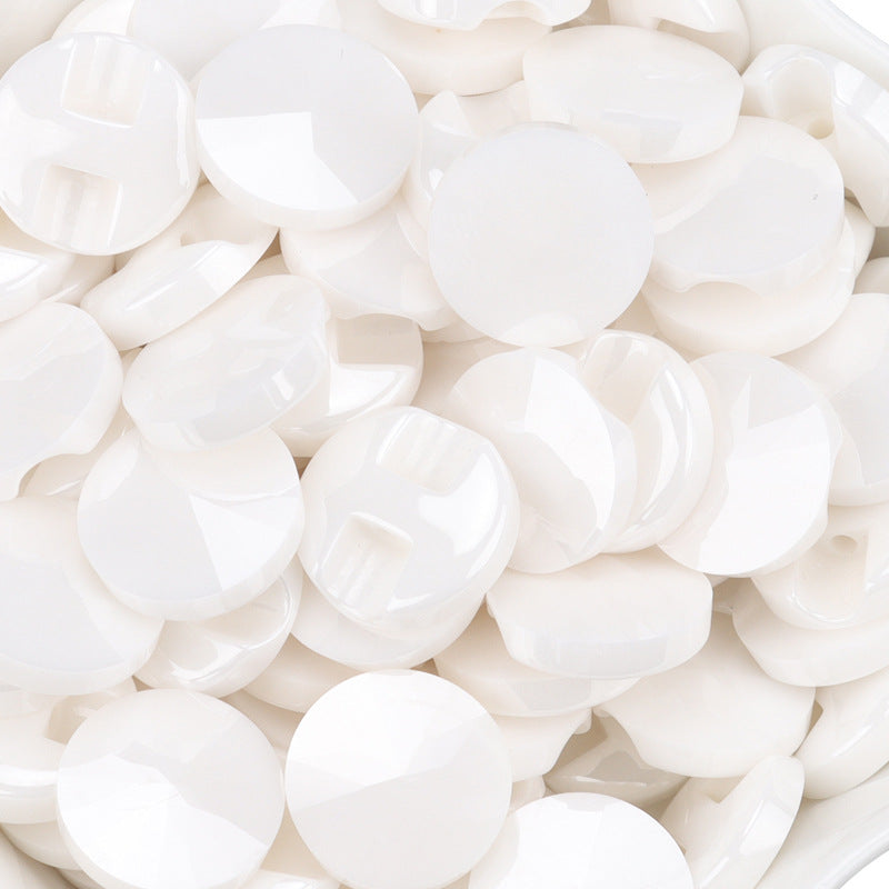 Pile of white ceramic shirt buttons with 4-hole faces, bulk pack