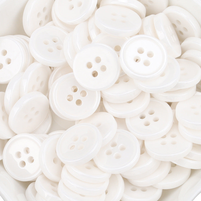 White ceramic shirt buttons with 4-hole design, stacked assortment