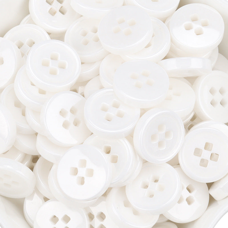 Close view of white ceramic 4-hole buttons, assorted angles