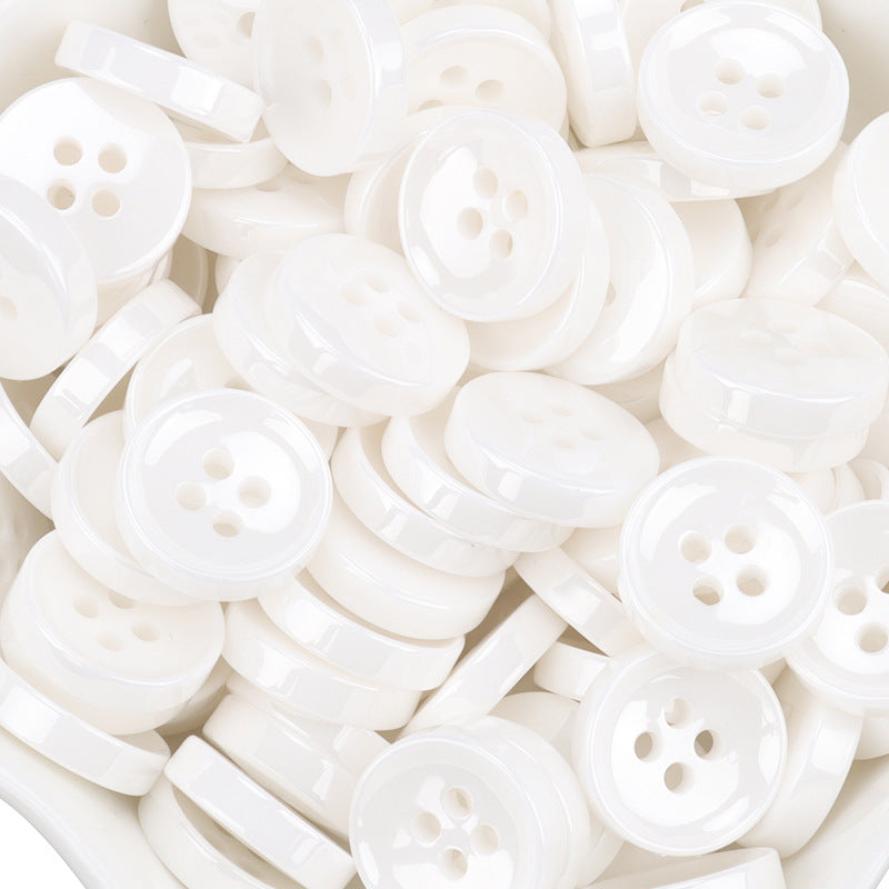 White ceramic shirt buttons, 11.5mm, four-hole fronts with some side edges visible