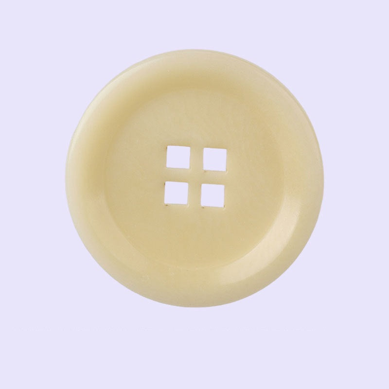 Beige corozo button with laser-cut square-hole cross, 15–25mm