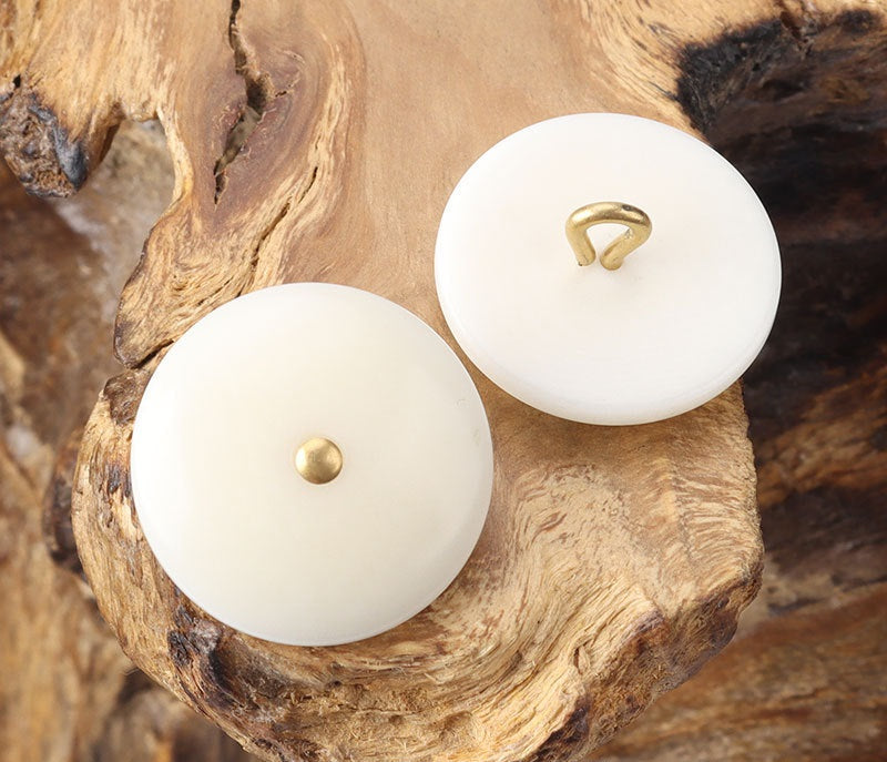White corozo shank buttons, round faces with brass shank openings