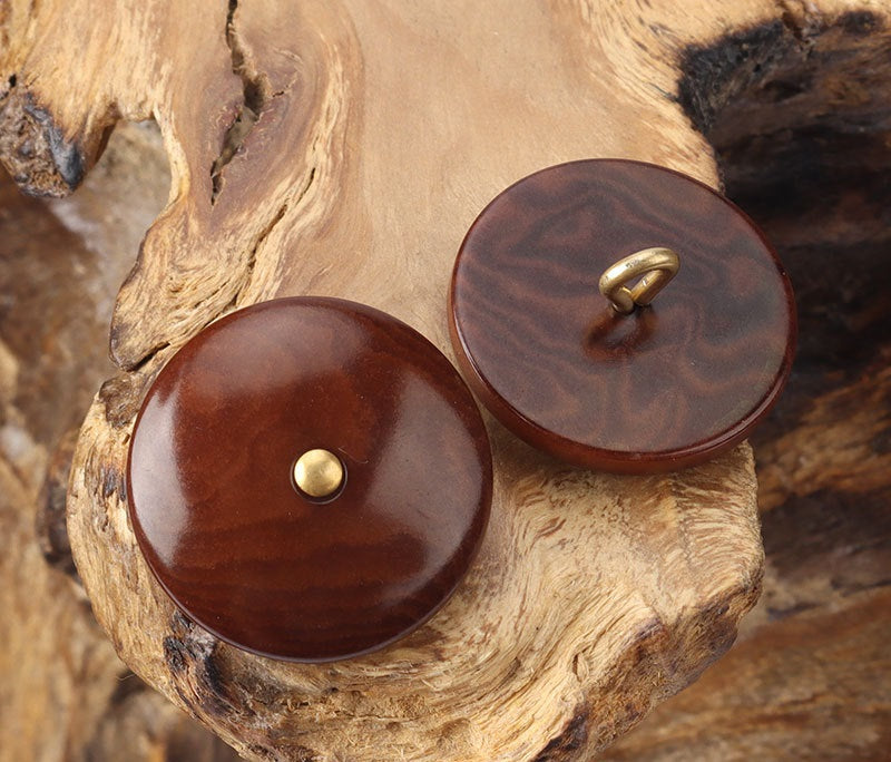 Brown corozo shank buttons, round shells with brass shank eye
