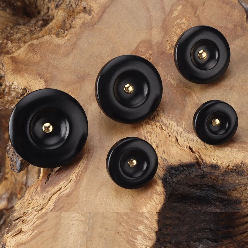 Black round corozo shank buttons, five-piece view with brass shanks