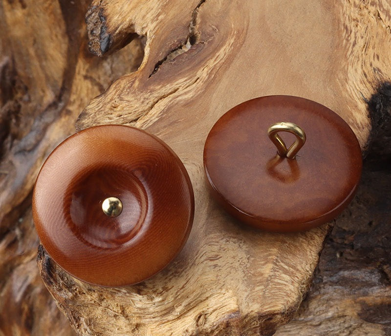 Brown and dark brown round corozo shank buttons with brass shanks, pair view