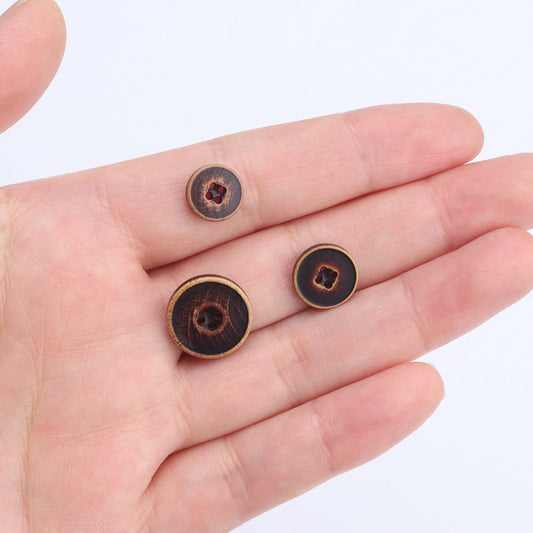 Light, dark brown and black poplar wood buttons in hand, round 4-hole style