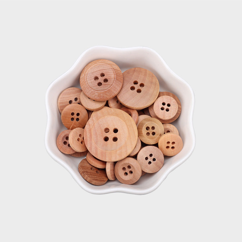 Pile of natural wood round buttons with four holes each