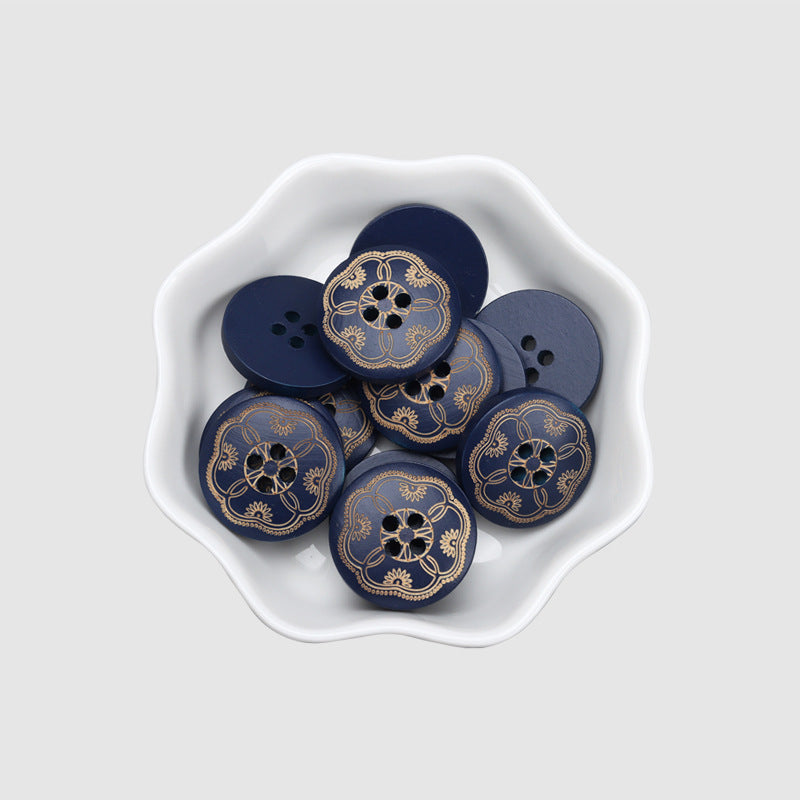 Bowl of round 4-hole dark blue wood buttons with gold ornate floral medallion