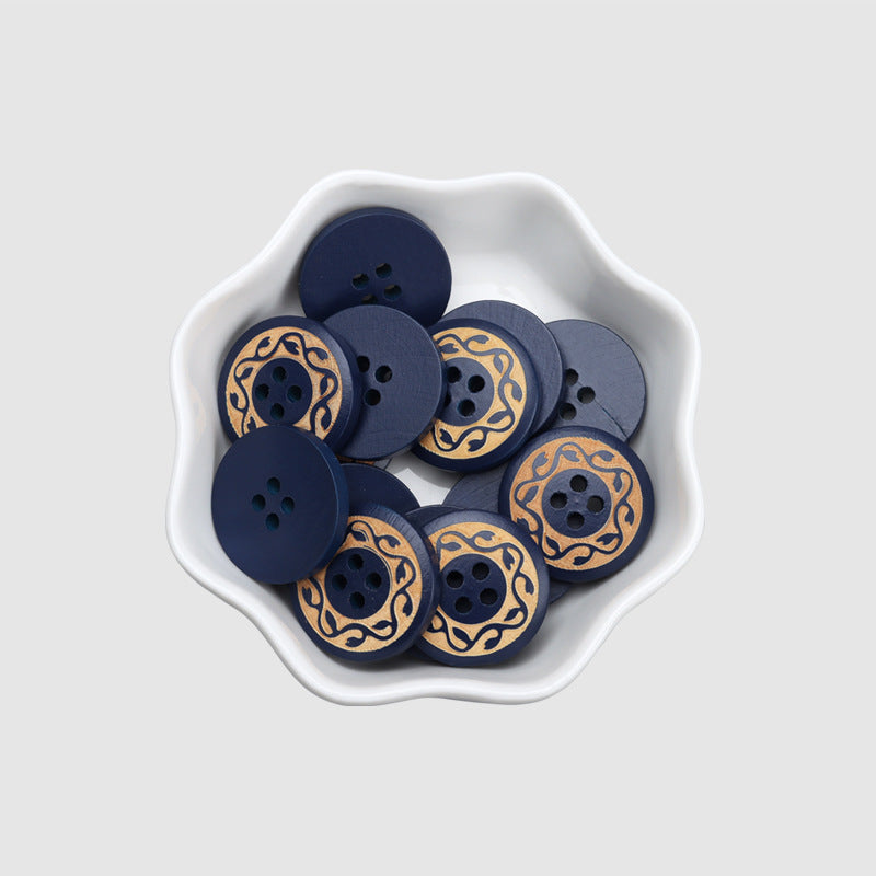 Bowl of round 4-hole dark blue wood buttons with gold vintage scroll medallion